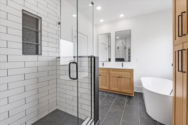 bathroom featuring recessed lighting, a shower stall, a soaking tub, and vanity