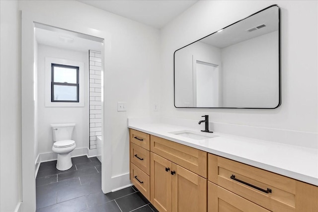 bathroom featuring toilet, visible vents, baseboards, tile patterned flooring, and vanity