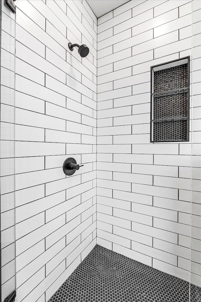bathroom with tiled shower