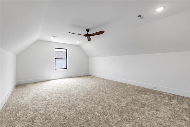 additional living space with ceiling fan, baseboards, lofted ceiling, carpet flooring, and visible vents