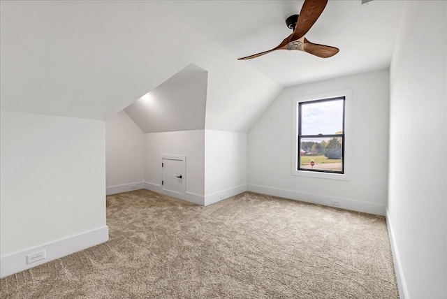 bonus room featuring lofted ceiling, baseboards, carpet flooring, and ceiling fan