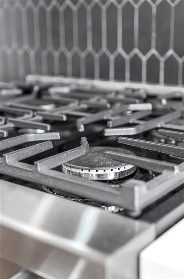 interior details featuring tasteful backsplash and range