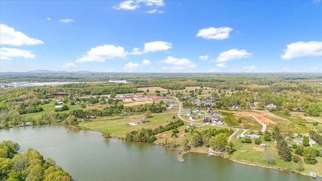 aerial view featuring a forest view and a water view