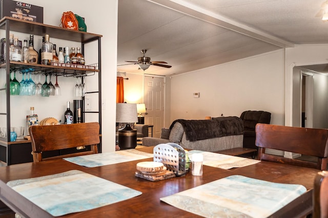 1005 Chris Dr, Portland, TN 37148 - dining space featuring wood finished floors, a ceiling fan, vaulted ceiling with beams, and a bar