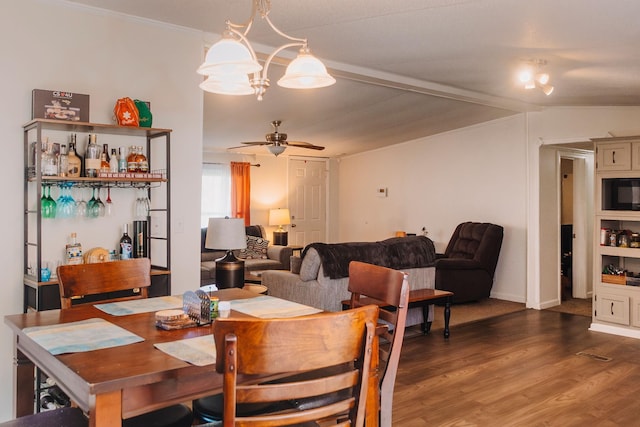 1005 Chris Dr, Portland, TN 37148 - dining space with crown molding, wood finished floors, lofted ceiling, and ceiling fan with notable chandelier