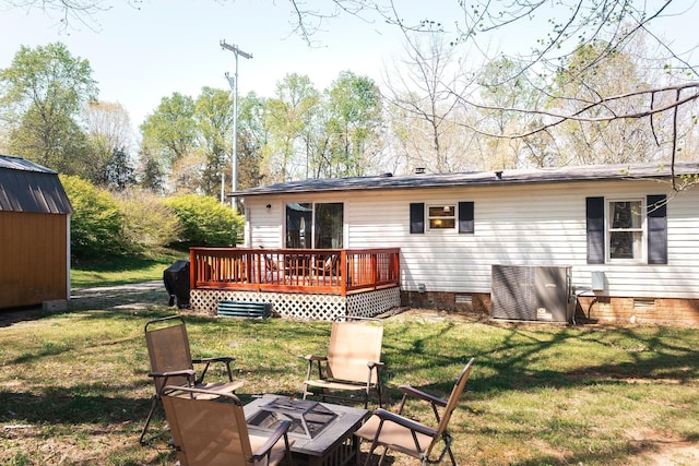 1005 Chris Dr, Portland, TN 37148 - back of house with a shed, crawl space, a wooden deck, a lawn, and a fire pit