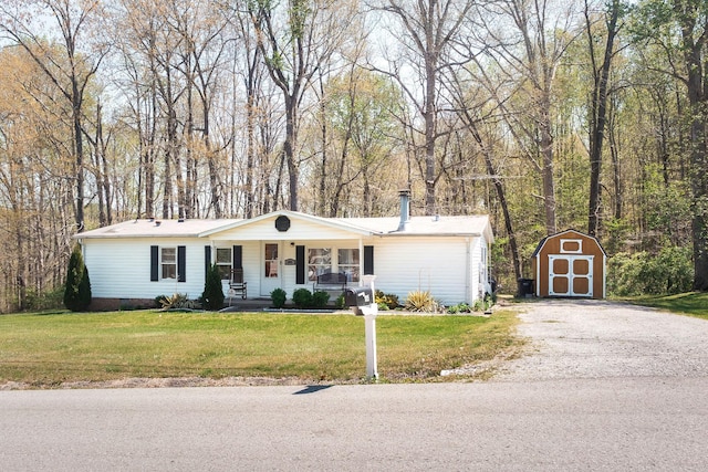 1005 Chris Dr, Portland, TN 37148 - ranch-style home with a storage shed, driveway, a porch, an outbuilding, and a front yard