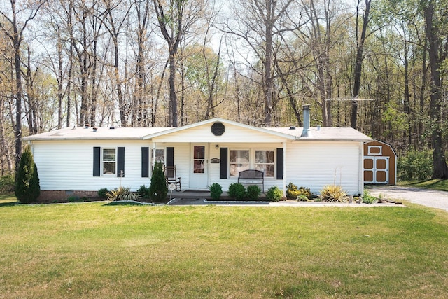 1005 Chris Dr, Portland, TN 37148 - ranch-style house featuring crawl space, a shed, covered porch, an outbuilding, and a front yard