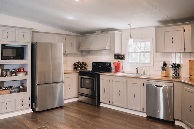 1005 Chris Dr, Portland, TN 37148 - kitchen with stainless steel appliances, light countertops, a sink, decorative backsplash, and custom exhaust hood