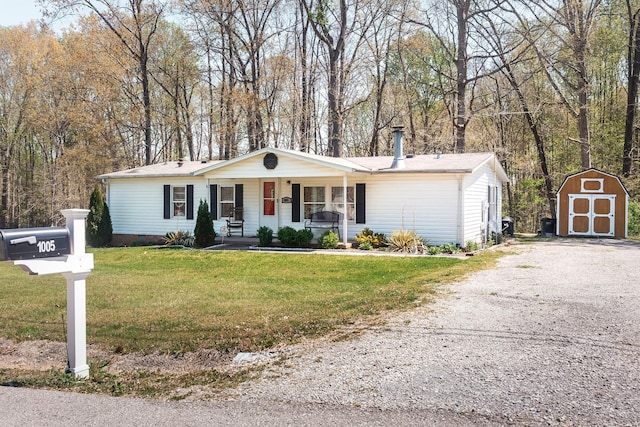 1005 Chris Dr, Portland, TN 37148 - ranch-style house with a shed, driveway, an outdoor structure, covered porch, and a front yard