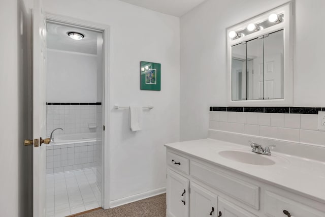 bathroom featuring baseboards, a garden tub, and vanity
