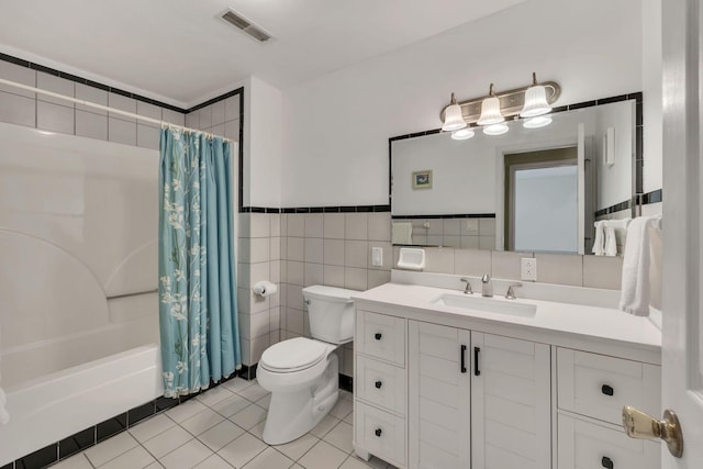 bathroom featuring toilet, tile walls, visible vents, tile patterned flooring, and vanity