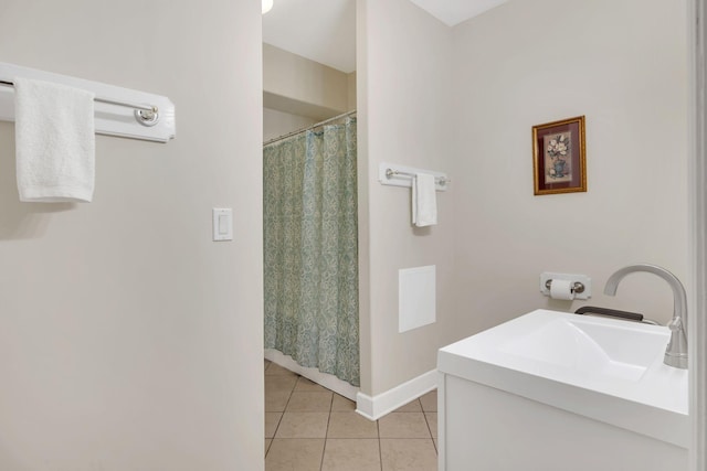 bathroom featuring tile patterned floors, baseboards, a sink, and a shower with shower curtain