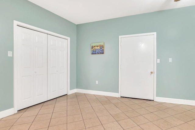unfurnished bedroom featuring a closet and baseboards