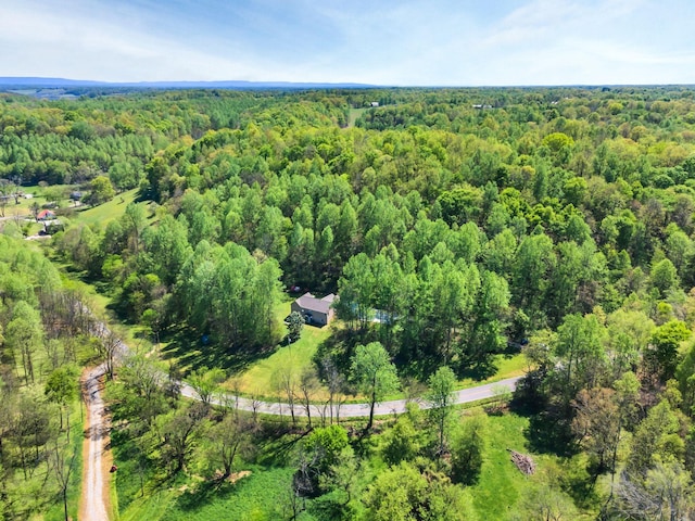 drone / aerial view featuring a view of trees