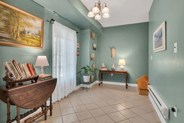 sitting room featuring a baseboard radiator, an inviting chandelier, light tile patterned flooring, and baseboards