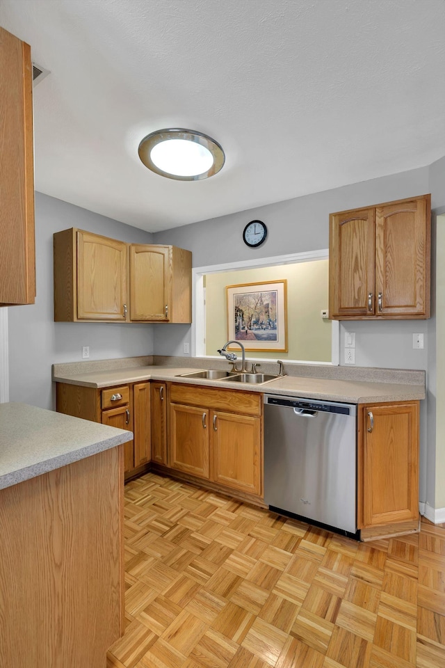 kitchen with dishwasher, light countertops, and a sink