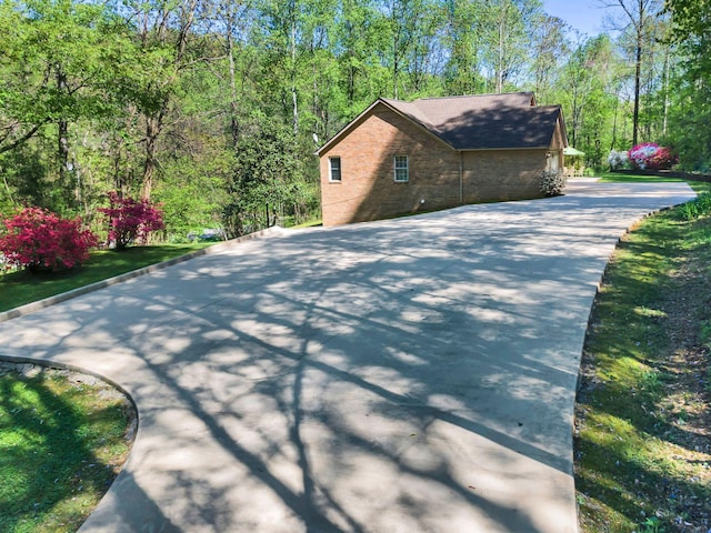 view of property exterior with roof with shingles