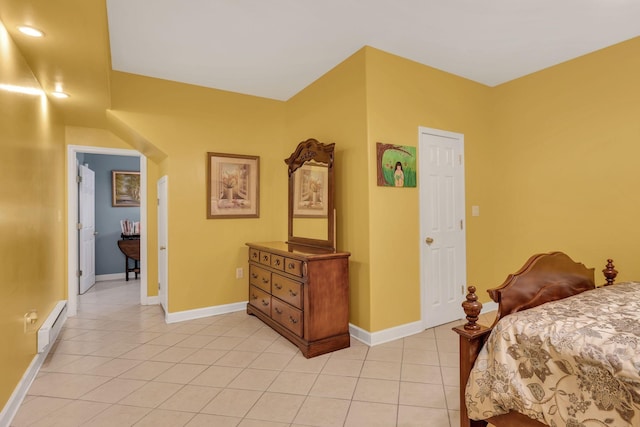 bedroom with baseboard heating, baseboards, and light tile patterned flooring