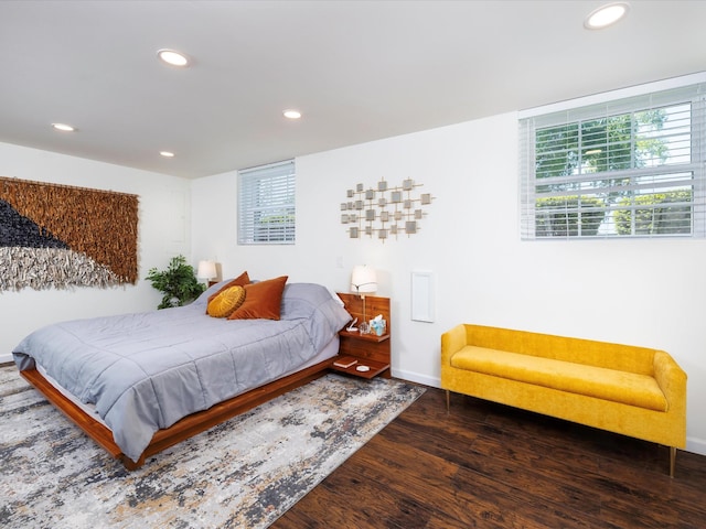 bedroom with baseboards, multiple windows, wood finished floors, and recessed lighting