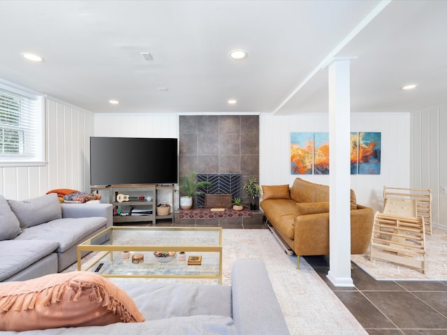 tiled living room featuring recessed lighting and a decorative wall