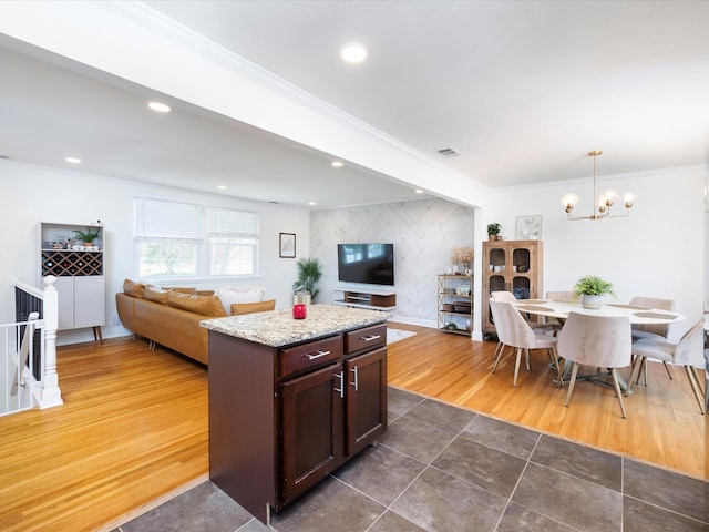 kitchen featuring open floor plan, a center island, an inviting chandelier, and recessed lighting