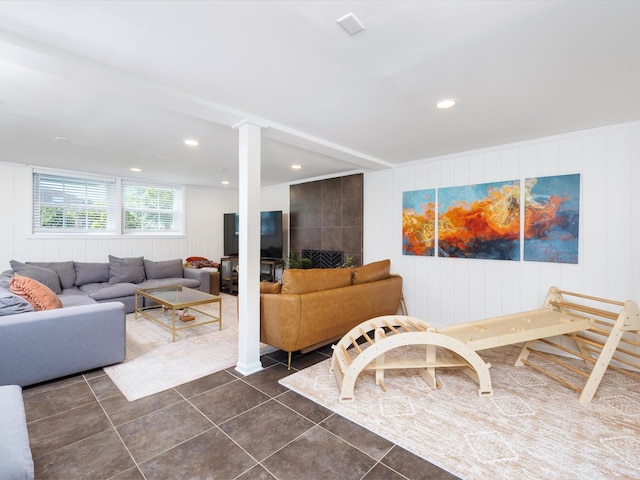 living room with dark tile patterned flooring and recessed lighting