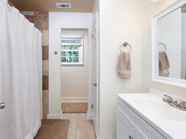 full bathroom featuring tile patterned floors, visible vents, vanity, and a tile shower