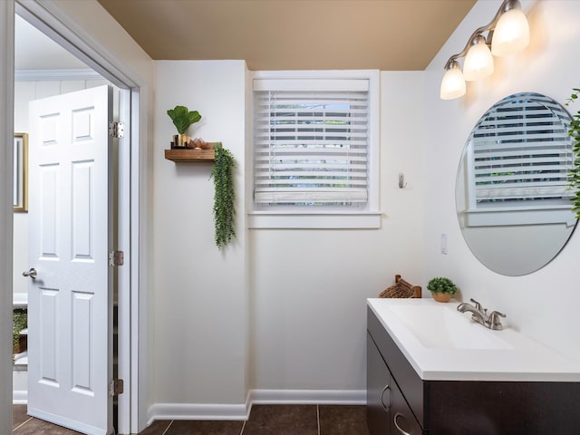 bathroom with baseboards, vanity, and tile patterned flooring