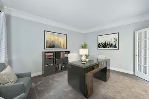 carpeted home office featuring baseboards and ornamental molding