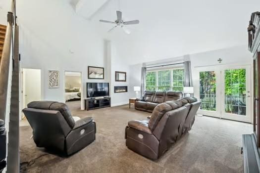 living room with high vaulted ceiling, carpet floors, healthy amount of natural light, stairway, and beamed ceiling
