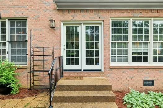 doorway to property with french doors and brick siding