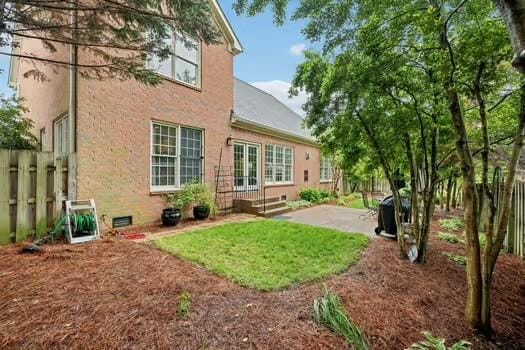 back of property featuring a patio and fence