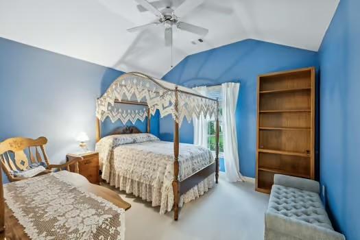 bedroom with vaulted ceiling, a ceiling fan, and carpet