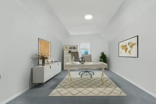 office area with baseboards and lofted ceiling