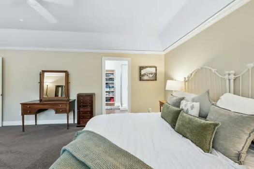 bedroom with beverage cooler, carpet, and baseboards