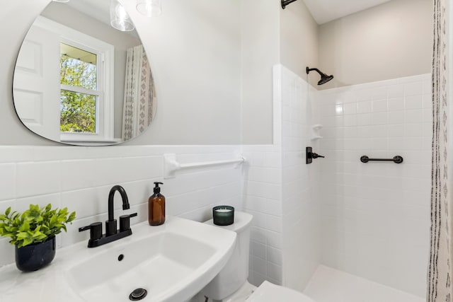 4052 Kings Ln, Nashville, TN 37218 - bathroom with a wainscoted wall, toilet, a sink, tile walls, and tiled shower
