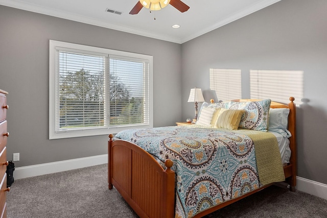 carpeted bedroom with a ceiling fan, baseboards, crown molding, and visible vents