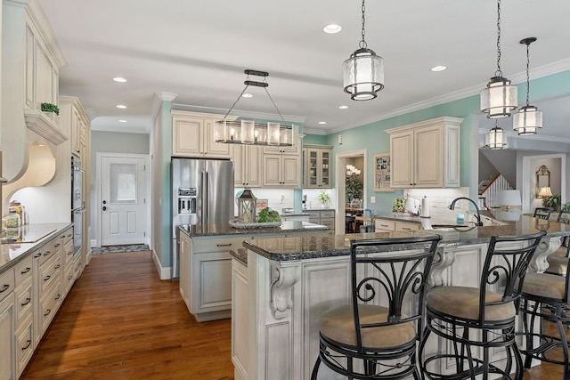 kitchen featuring recessed lighting, a breakfast bar, a sink, a kitchen island, and tasteful backsplash