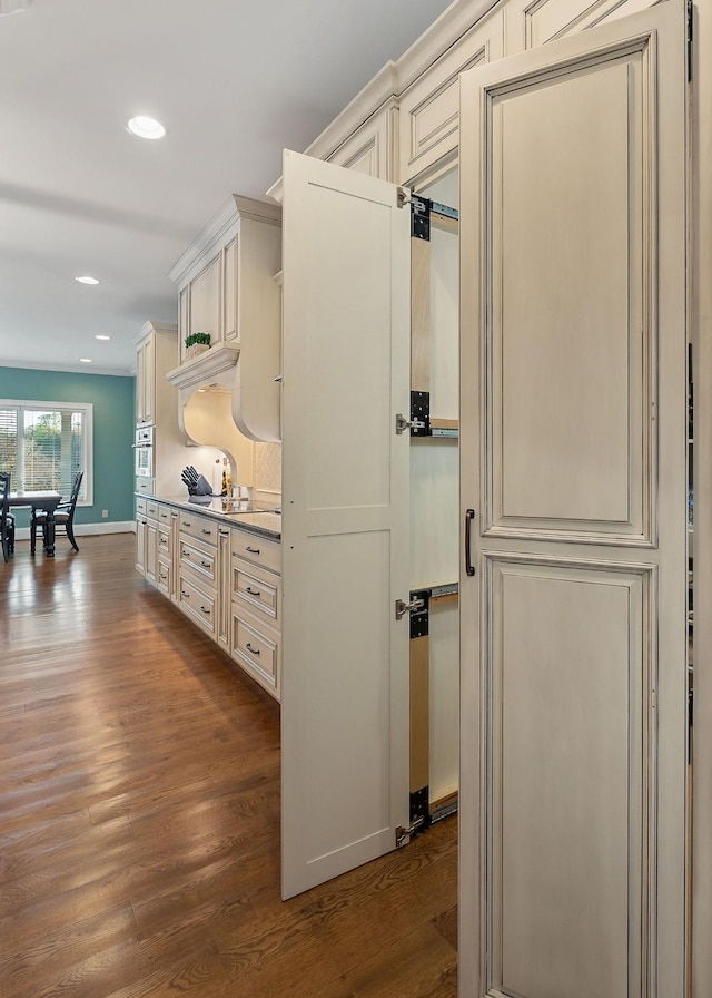 interior space with baseboards, dark wood-style floors, and recessed lighting