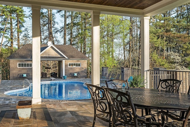 view of swimming pool featuring an exterior structure, a patio area, a fenced in pool, and an outbuilding