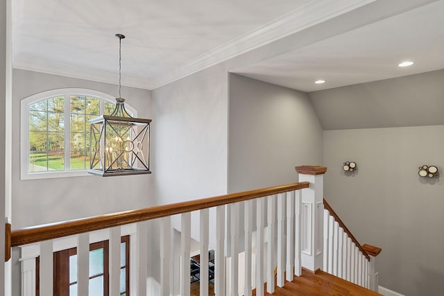 stairs with baseboards, recessed lighting, lofted ceiling, wood finished floors, and ornamental molding