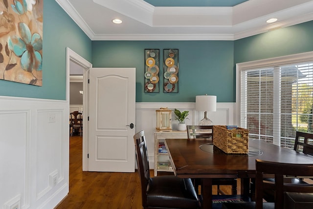 dining room featuring wainscoting, recessed lighting, wood finished floors, a decorative wall, and ornamental molding