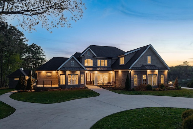 view of front of property with a front lawn, a standing seam roof, and metal roof