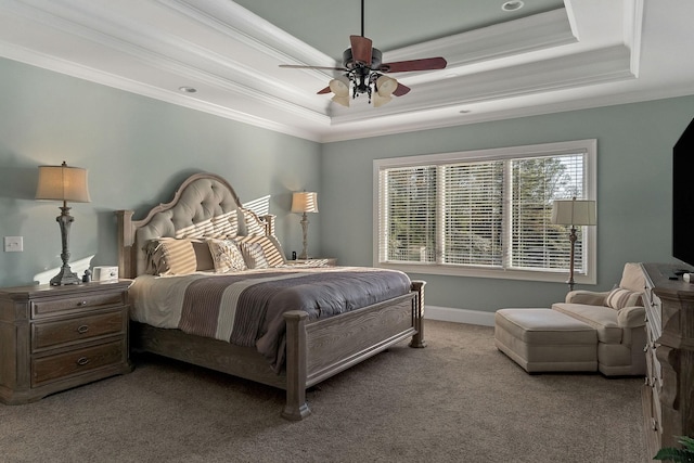 carpeted bedroom featuring a raised ceiling, crown molding, baseboards, and a ceiling fan