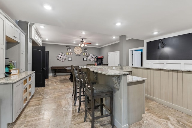kitchen with recessed lighting, crown molding, and a ceiling fan