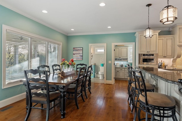 dining space featuring baseboards, visible vents, and plenty of natural light