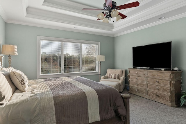 bedroom with a raised ceiling, carpet, and ornamental molding