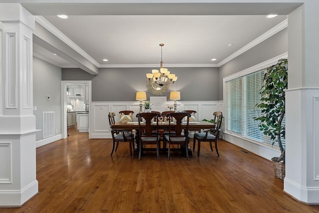 dining space featuring recessed lighting, wood finished floors, visible vents, and decorative columns