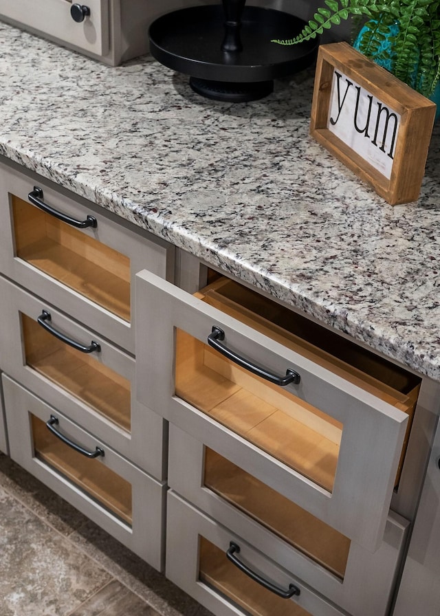 room details featuring open shelves and light stone countertops
